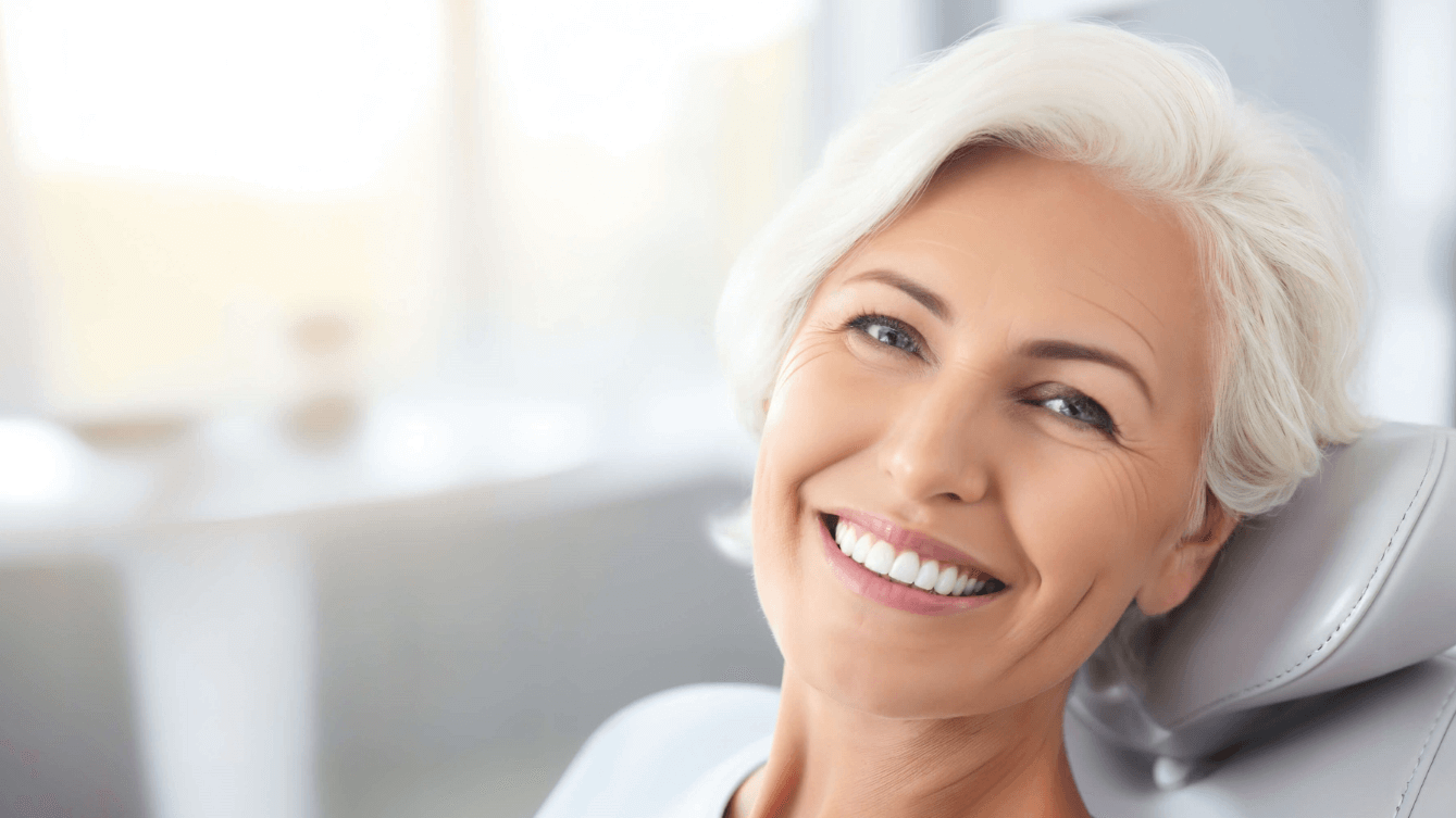 older woman smiling at dentist